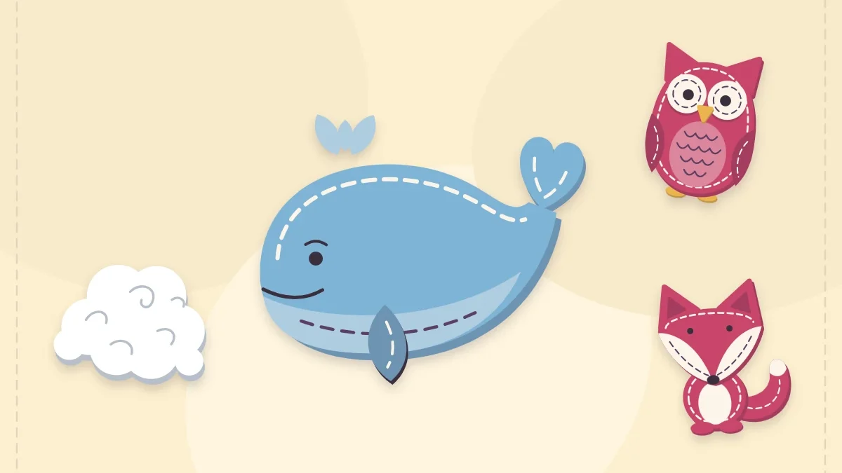 Stuffed felt whale with a small felt owl and fox beside it