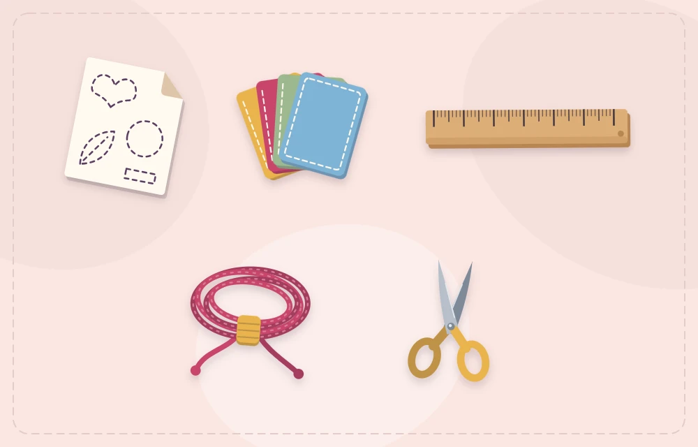 A paper template with felt sheets, a ruler, cord and scissors