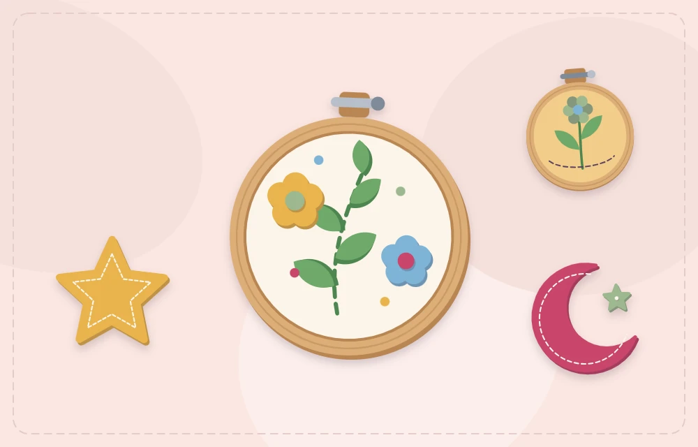 A felt design framed in a wooden embroidery hoop with a moon and a star beside it