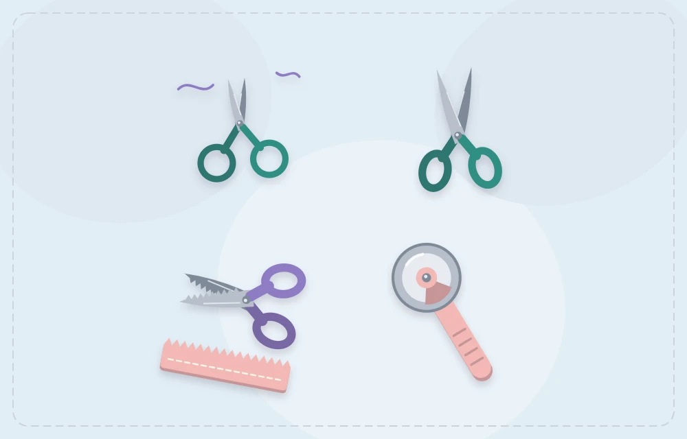 Small detail scissors, fabric scissors, pinking shears and a rotary cutter laid out together