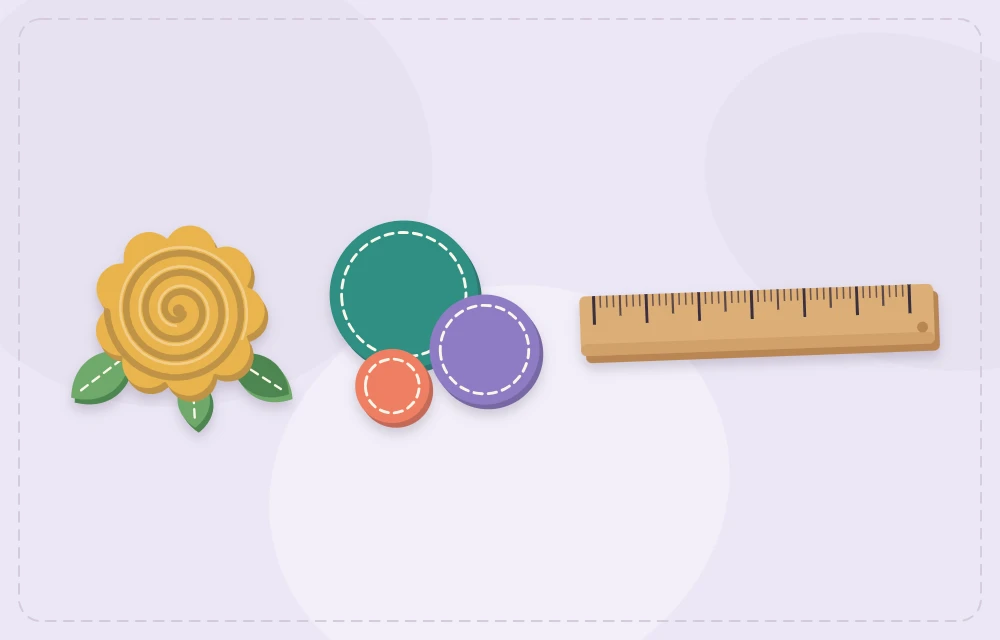 A rolled felt rose next to felt circles of different sizes and a ruler